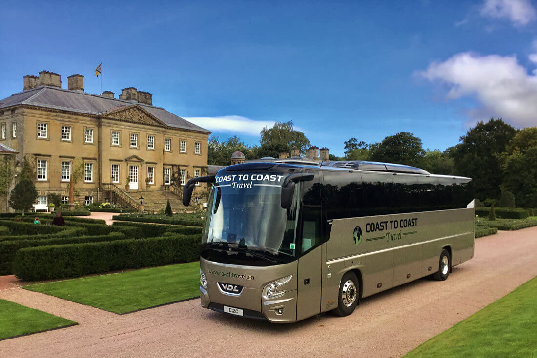 18 seater mini-coach parked next to the gardens at Dumfries House in East Ayrshire
