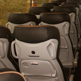 Interior view of Coast to Coast Travel coach showing rows of seats from the back
